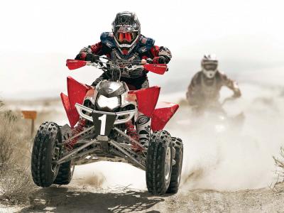 2011.polaris.outlaw525irs.red_.front_.riding.on-dirt.jpg