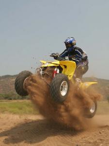 2010.suzuki.ltz400.yellow.front-left.jumping.in-sand.jpg