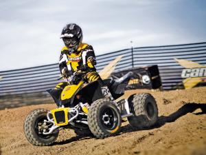 2011.can-am.ds90.front-right.yellow.riding.on-trail.jpg