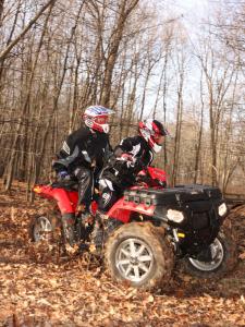 2011.polaris.sportsman-touring850eps.red_.right_.riding.in-woods.jpg