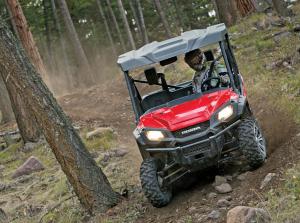2016.honda.pioneer1000.red.front.riding.on-path.jpg
