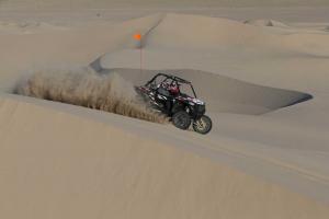 2016.polaris.rzr-xp-turbo-eps.grey_.right-far.riding.at-dunes.jpg